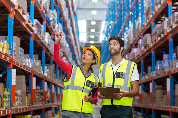 female and male warehouse workers in vests